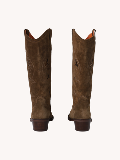 Pair of brown cowboy boots on a white background